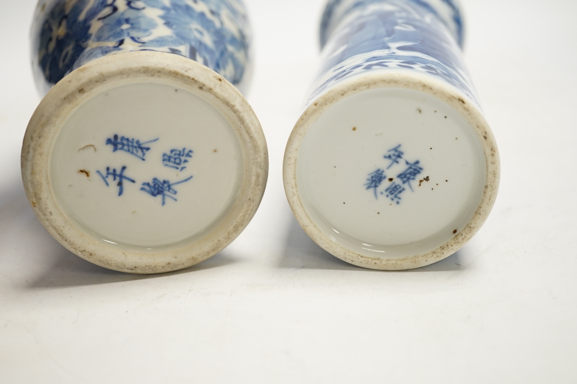 Two early 20th century Chinese blue and white vases, one restored, 23cm